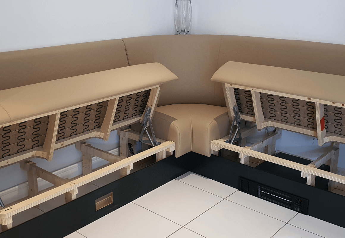 corner banquette bench seat with hinged storage within the base seat