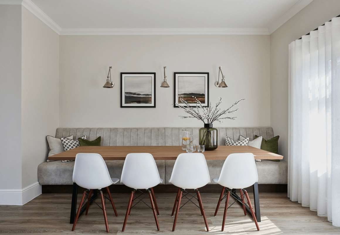 grey kitchen bench seat fixed to a wall in a fluted back design with dining table in front