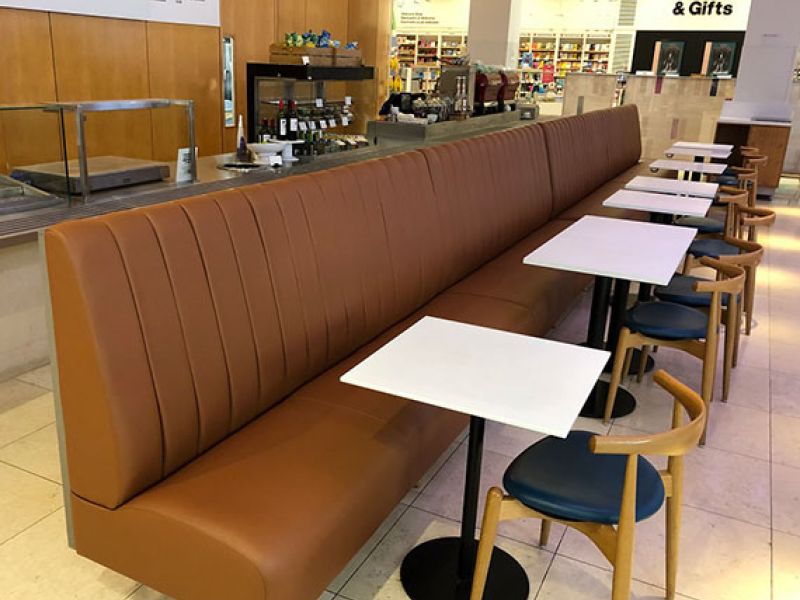 Fluted back dining banquette bench in a tan faux leather