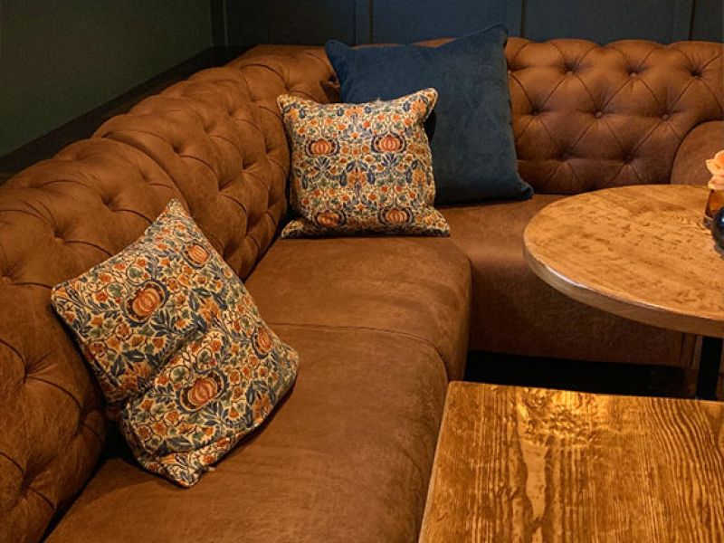 corner banquette seat in a chesterfield button back style